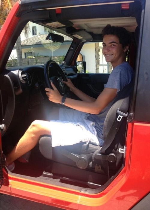 Logan Grove as seen while smiling in a picture in his first car in July 2014