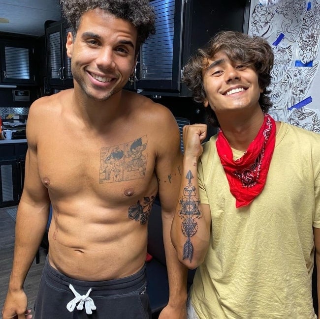 Mason Gooding (Left) smiling shirtless for a picture alongside Michael Cimino in July 2020
