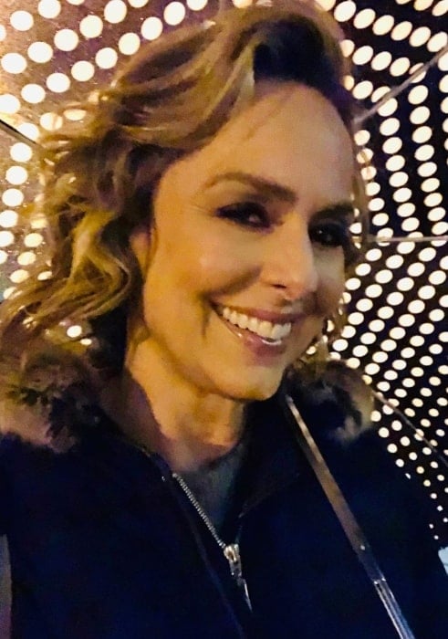 Melora Hardin walking to her home in the rain in October 2019