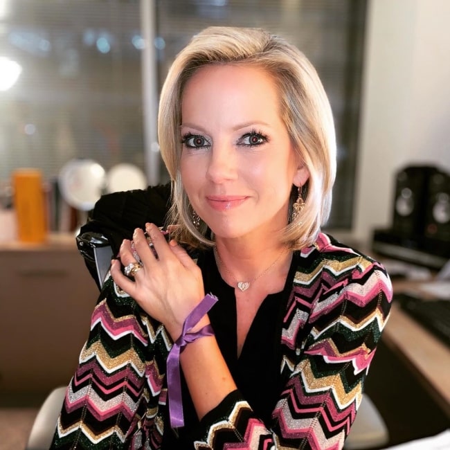 Shannon Bream as seen while smiling for a picture showing her necklace in February 2020