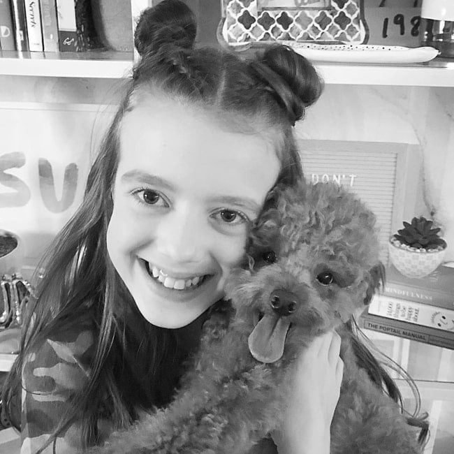 Symonne Harrison feeling happy with a happy dog in October 2018