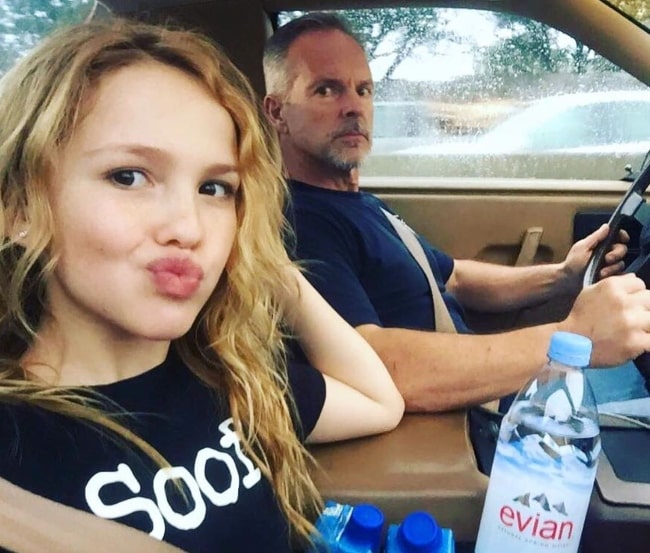 Talitha Bateman pouting for a car selfie alongside her father