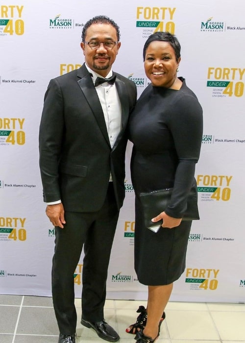 Kellie Shanygne Williams as seen while smiling for the camera alongside her husband at the George Mason University Black Alumni Forty Under 40 event in October 2019