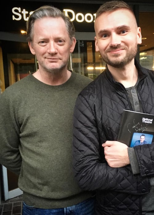 Douglas Henshall posing for a photograph with a fan, in March 2018