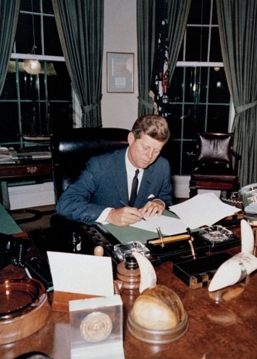 John F. Kennedy pictured while signing the Proclamation for Interdiction of the Delivery of Offensive Weapons to Cuba at the Oval Office on October 23, 1962