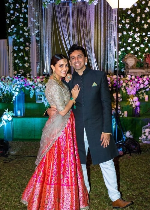 Nisha Agarwal as seen while smiling for a picture alongside husband Karan Valecha