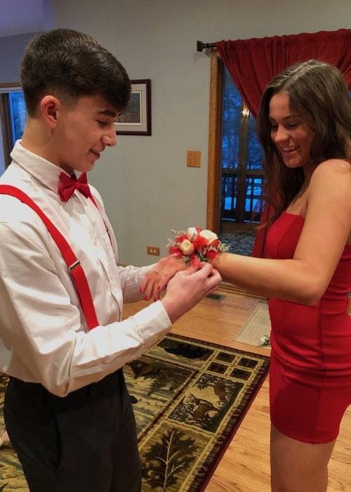 threedotcorey as seen in a picture while tying a wrist corsage brooch on Marissa Gulley's hand in February 2019
