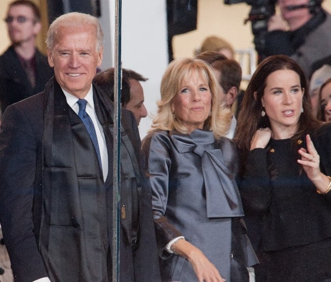 Ashley Biden (Right) and her parents watching the Ballou Senior High School majestic Marching Knights pass in front of the presidential inauguration parade official review stand in January 2013
