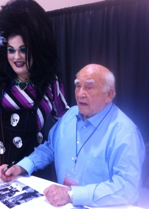 Ed Asner posing with a fan in September 2012