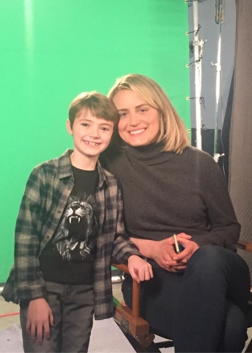 Jackson Robert Scott posing for a picture along with Taylor Schilling in April 2018