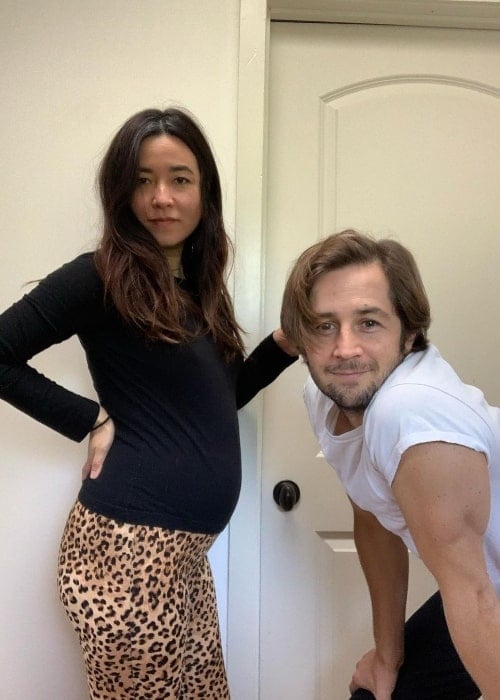 Maya Erskine posing for the camera along with Michael Angarano and showing her baby bump in November 2020