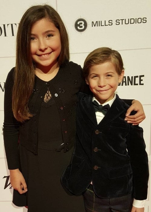 Emma Tremblay smiling for the camera alongside her brother during an event