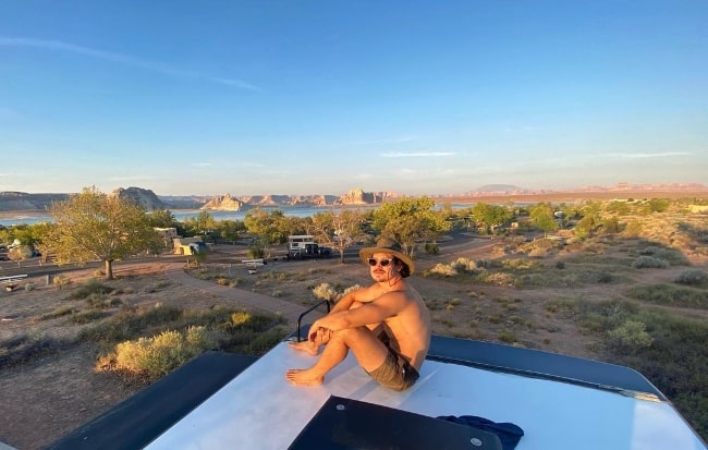 Henry Zaga posing shirtless for a picture at Lake Powell, Utah in August 2020
