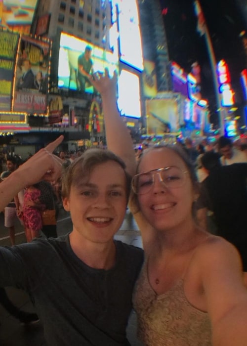 NoughtPointFourLIVE in a selfie that wa taken with his beau Louise Bache in Times Square, New York City in June 2018
