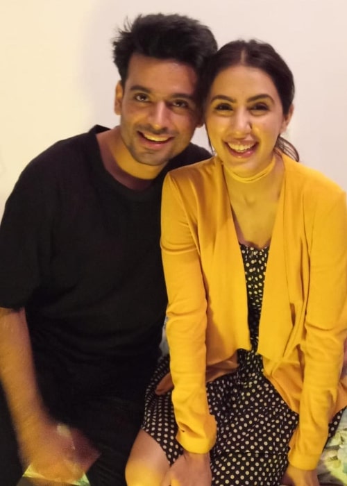 Swati Kapoor smiling for a picture alongside Anuj Sikri in December 2018