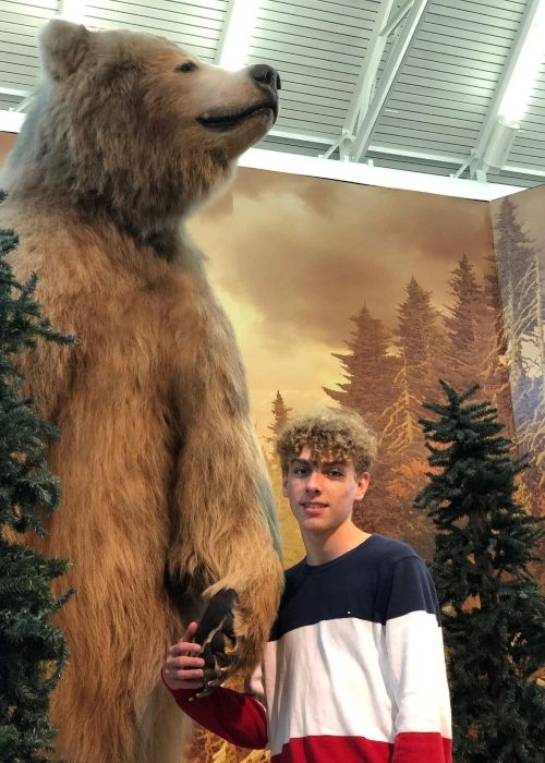 DJ Cook as seen in a picture besides a bear in September 2019