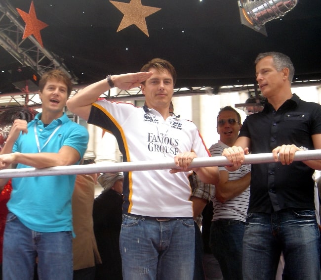 From Left to Right - Scott Gill, John Barrowman (saluting in the style of Captain Jack Harkness), and politician Brian Paddick on a float at the 2007 London Gay Pride