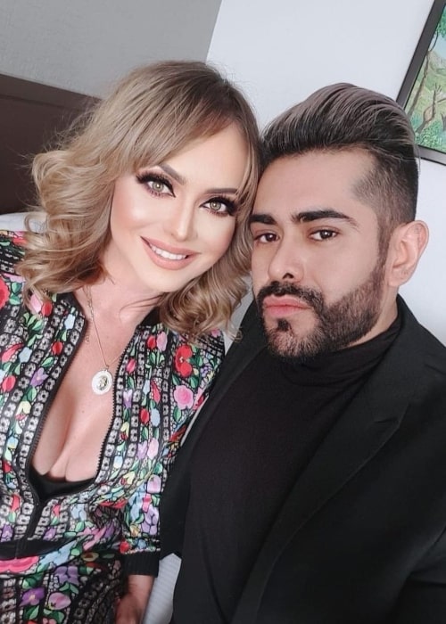 Gabriela Spanic smiling for a picture alongside Miguel Sanroman Rubio in January 2021