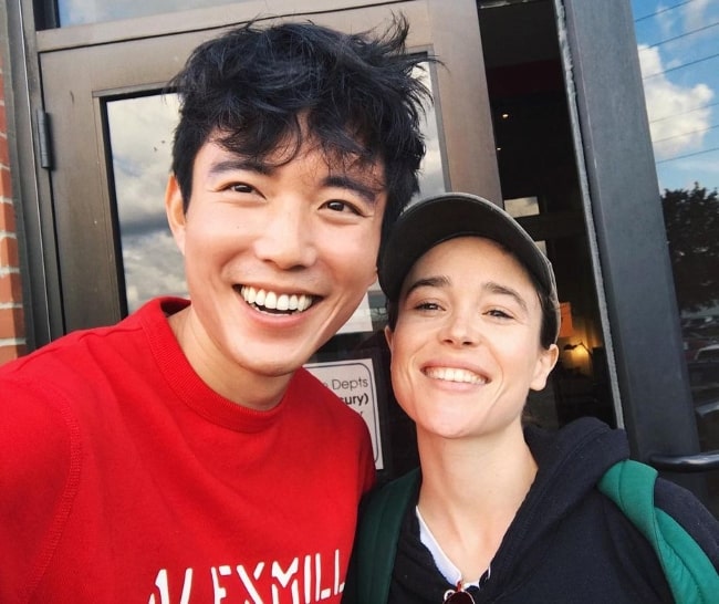 Justin H. Min (Left) smiling in a selfie alongside Elliot Page in Toronto, Ontario in September 2019