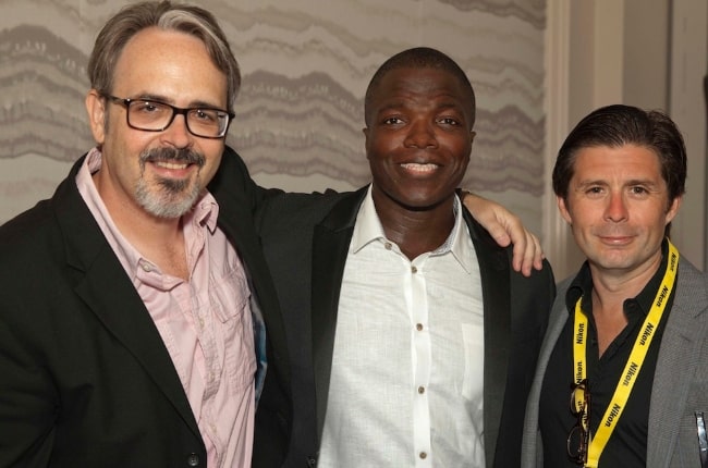 The producer of the movie titled 'The Week' posing for the camera alongside Reno Wilson (Center) and Rick Gomez (Right) in June 2015