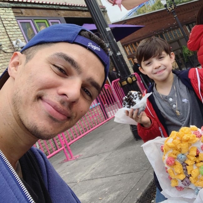 Andrew Jacobs enjoying original Voodoo Doughnuts with his son in September 2019