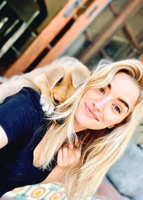 Brianne Howey smiling for a picture with her dog in May 2020