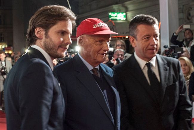 (From left to right) Daniel Brühl, Niki Lauda, and Peter Morgan as seen in 2013