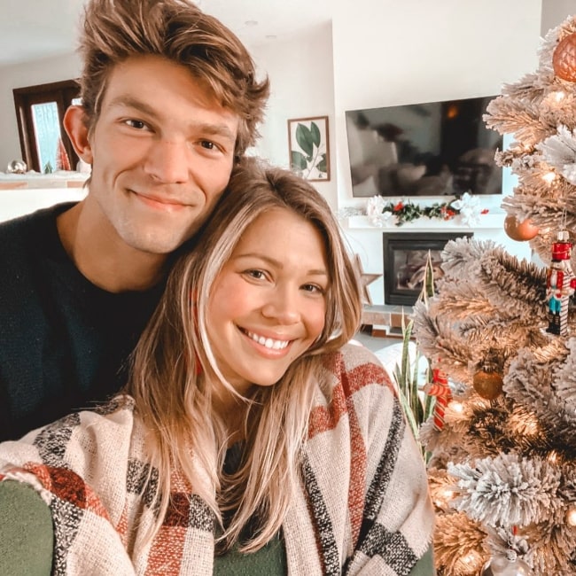 Krystal Nielson with her sweetheart in January 2021 sneaking in one last picture from Christmas 2020 with the beautiful Christmas Tree