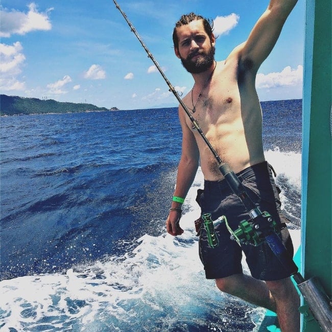 Luke Kleintank as seen while posing shirtless for a picture while fishing in Koh Tao