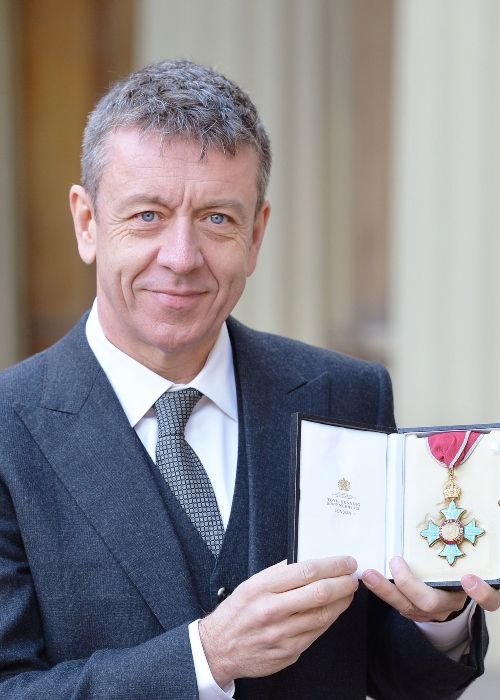 Peter Morgan as seen posing with his CBE award in 2016