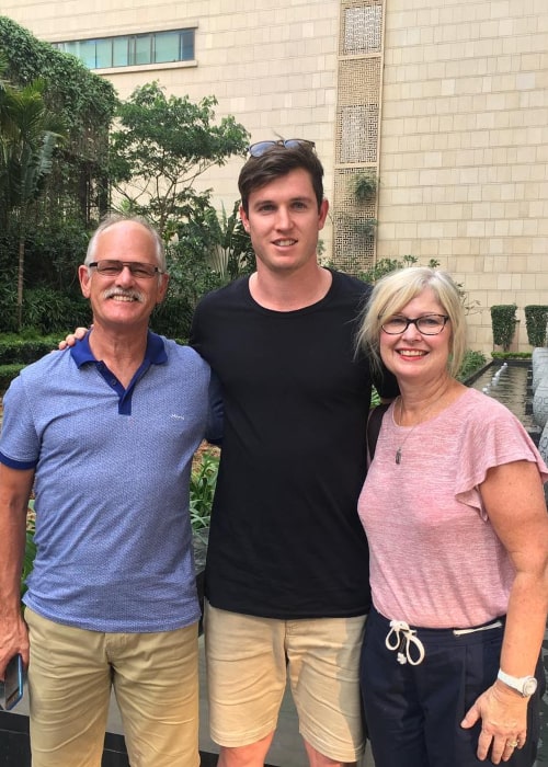 Adam Milne with his parents, as seen in April 2017