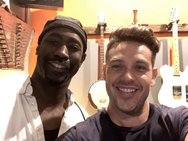 D. B. Woodside (Left) smiling in a selfie alongside Kevin M Alejandro