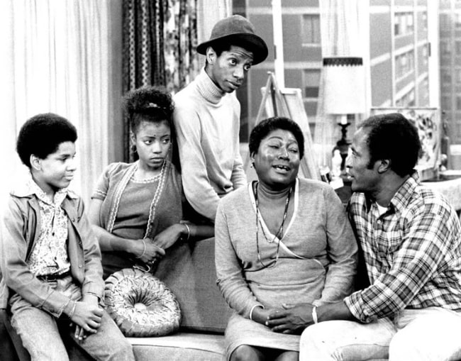 From Left to Right - Ralph Carter, BernNadette Stanis, Jimmie Walker, Esther Rolle, and John Amos as seen in a photo of the Evans family from the television program 'Good Times'