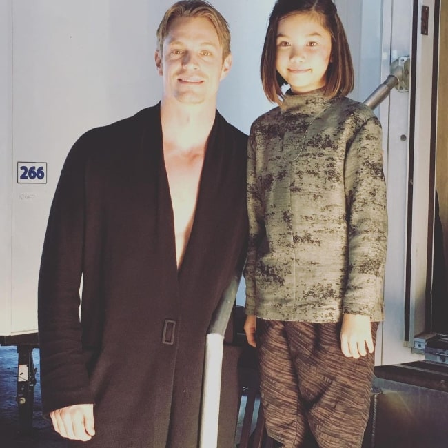 Riley Lai Nelet smiling for a picture alongside Joel Kinnaman