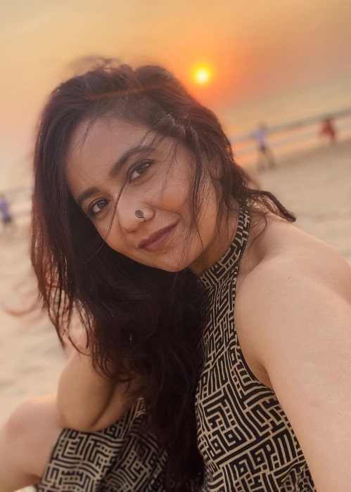 Roopal Tyagi taking a selfie while enjoying a sunset at a beach in March 2021