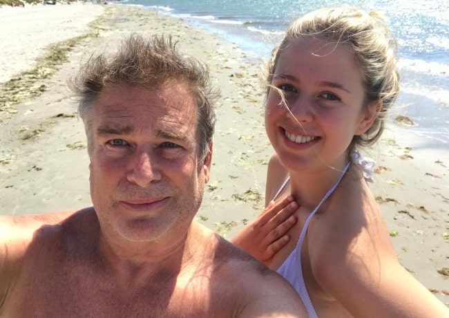 Aliya Kapoor smiling in a selfie with her father at West Wittering Beach in West Wittering, England in July 2018