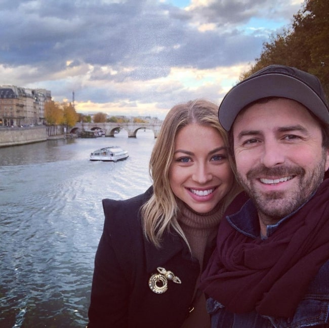 Beau Clark smiling in a selfie alongside Stassi Schroeder in Paris, France