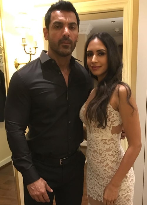 Priya Runchal posing for the camera alongside John Abraham in February 2019