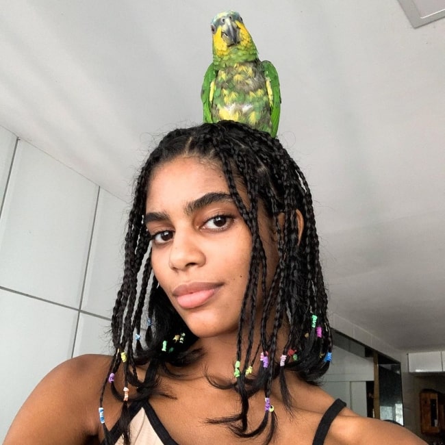 Allana Santos Brito as seen in a selfie with a parrot that was taken in Salvador, Bahia, Brasil in April 2020