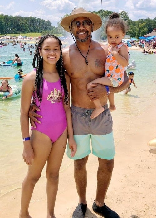 DJ Fadelf posing for a picture with his daughters at a beach in July 2021