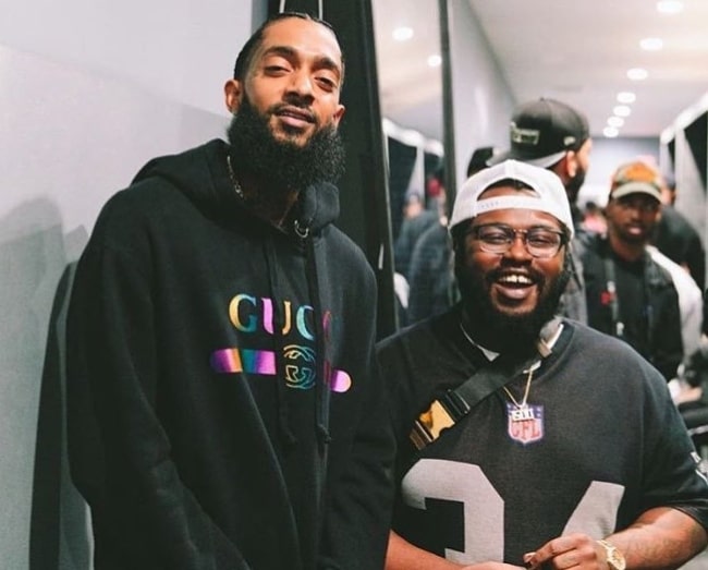 James Fauntleroy (Right) smiling for the camera alongside Nipsey Hussle