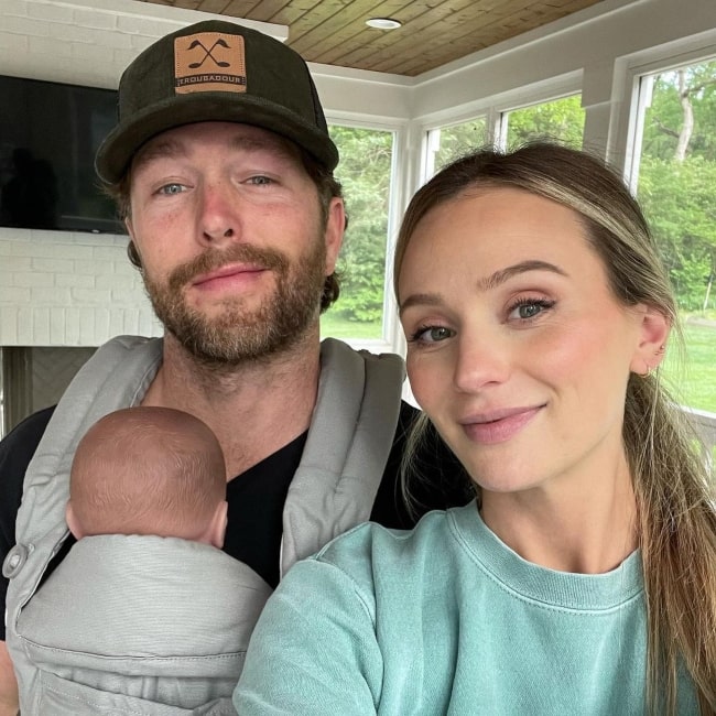 Lauren Bushnell and her husband attending a preparatory Baby 101 class with a model of a baby in May 2021