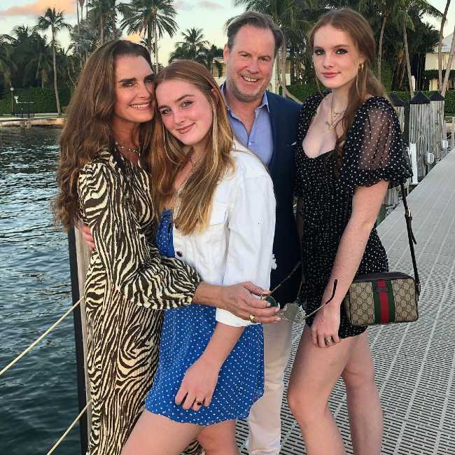 Rowan (in blue dress) seen with her family in 2020