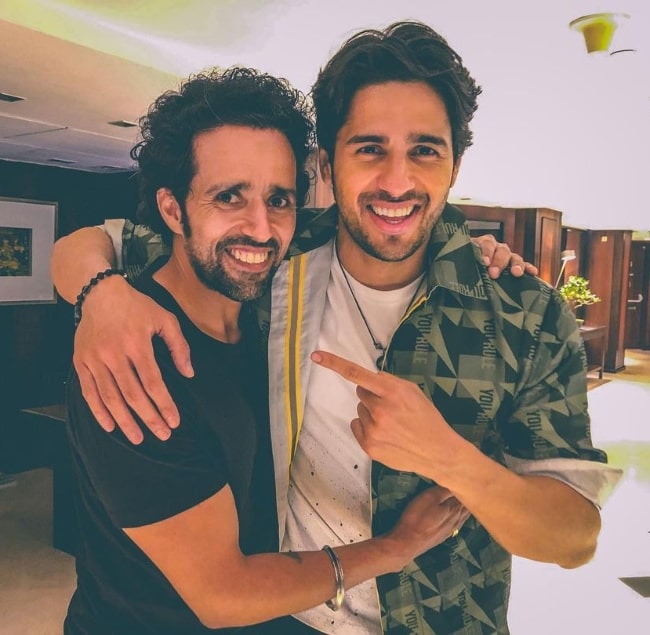 Anil Charanjeett (Left) as seen while smiling for a picture alongside his 'Shershaah' co-actor Sidharth Malhotra in August 2021