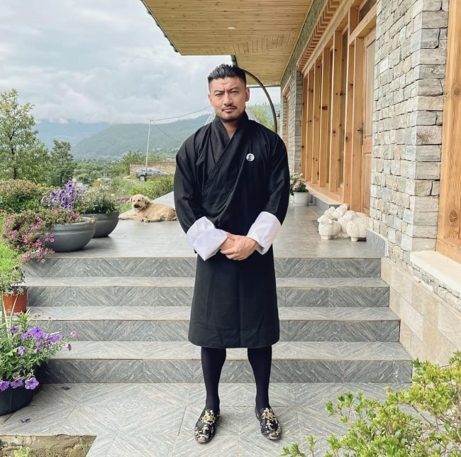 Sangay Tsheltrim posing for a picture in a traditional dress in Bhutan