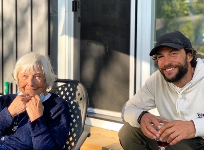 Kyle Schmid smiling for a picture with his grandmother in February 2021