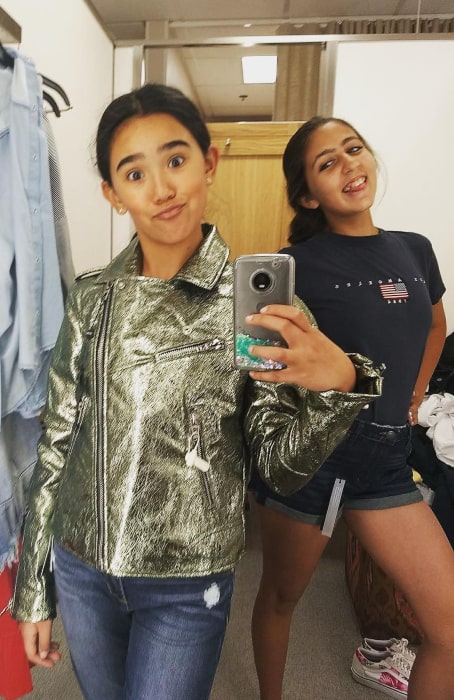 Jolie Hoang-Rappaport in August 2018 striking a pose while shopping with her friend