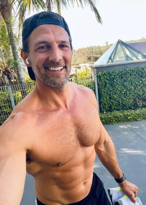 Tim Robards smiling in a shirtless selfie showing his stunning physique in October 2021