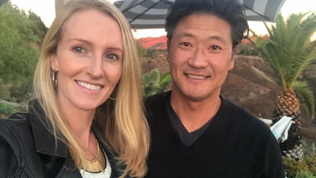 Tom Choi smiling for a picture alongside his wife Jill Renninger