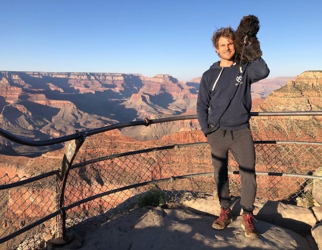 Travis Van Winkle posing for a picture at the Grand Canyon with his dog in June 2020